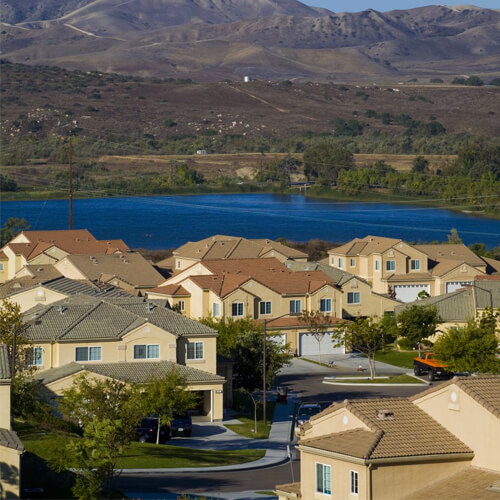 Aerial Shot Of Community With Lake In Background