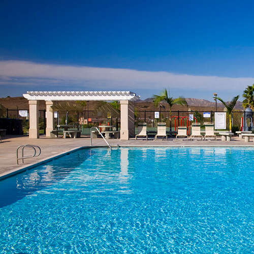 Pool With Blue Water And Lounge Chairs